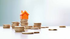 tiny orange house on stack of coins